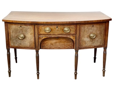 Lot 411 - A late George III mahogany and crossbanded bow front sideboard.