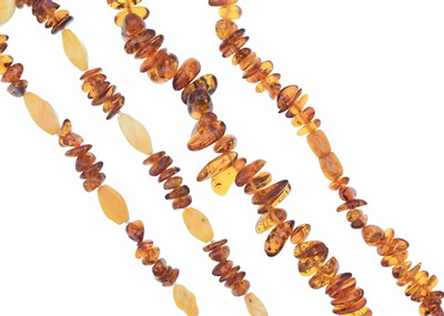Lot 102 - A selection of two amber bead necklaces.