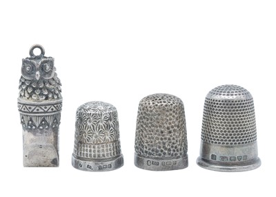 Lot 13 - A novelty owl whistle, together with three silver thimbles.