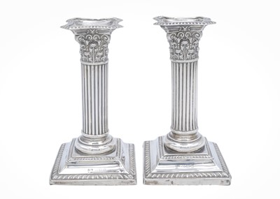 Lot 17 - A pair of Edward VII silver Corinthian candlesticks by Henry Matthews.