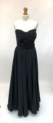 Lot 3030 - An elegant sleeveless black full length...