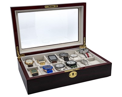 Lot 1034 - A collection of eleven quartz wristwatches, within a 12 section watch storage box.