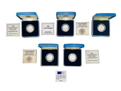 Lot 127 - A selection of five Royal Mint silver-proof one pound £1 coins, with boxes and certificates.