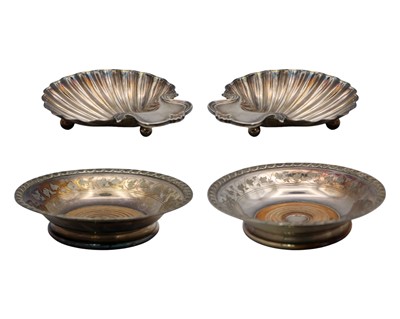 Lot 218 - A pair of silver-plated wine coasters and a pair of silver-plated on copper scallop dishes.