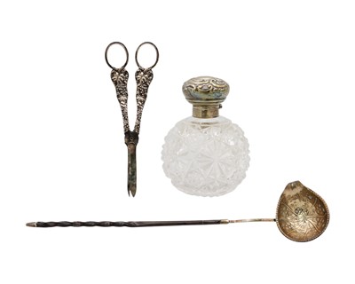 Lot 63 - A silver topped cut-glass scent bottle, toddy ladle and pair of plated grape scissors.