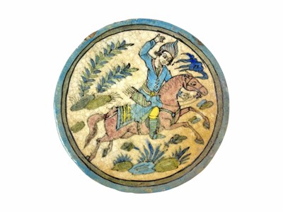 Lot 523 - A large circular earthenware tile, polychrome decorated in the Iznik style.