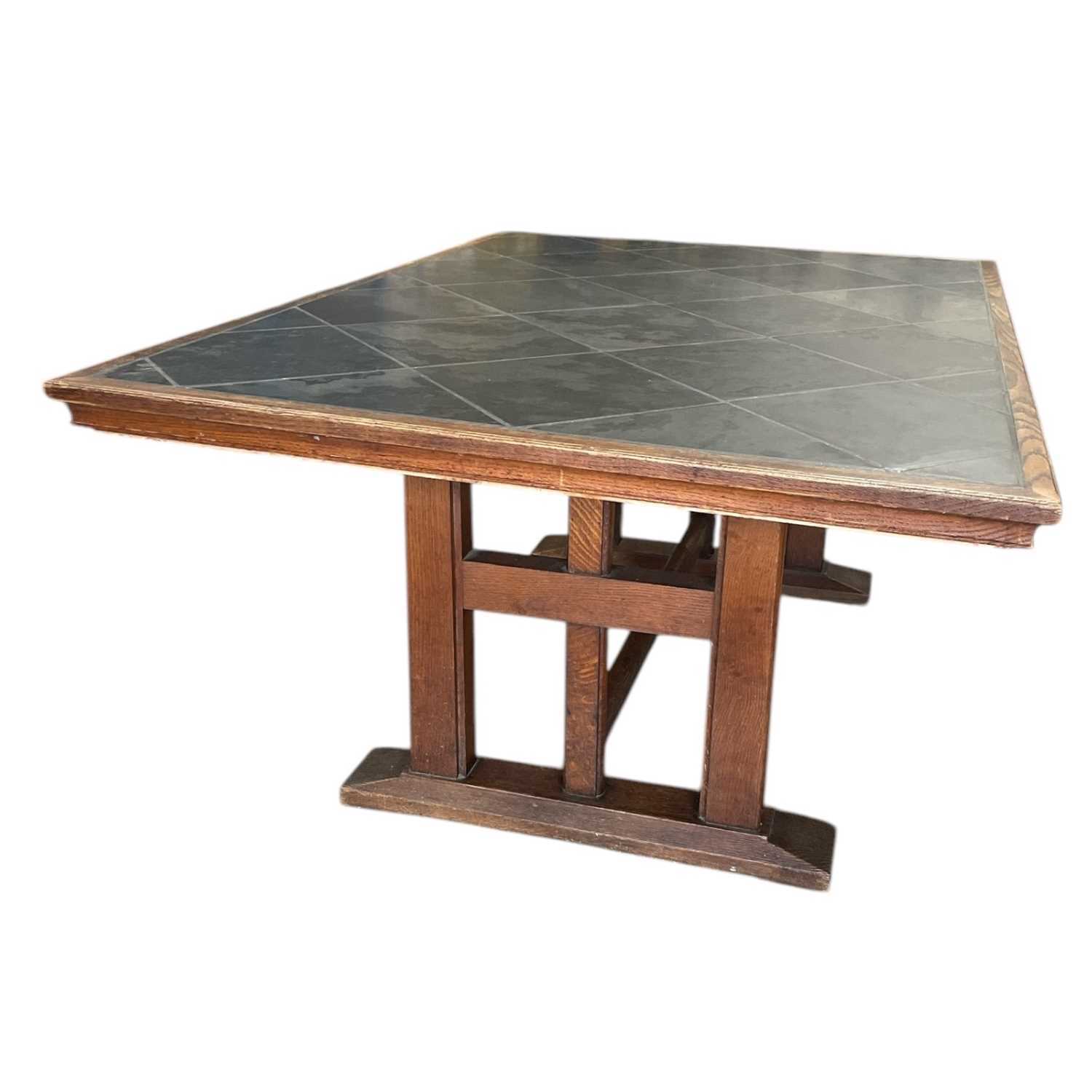 Lot 27 - A substantial, oak table with a slate inlay