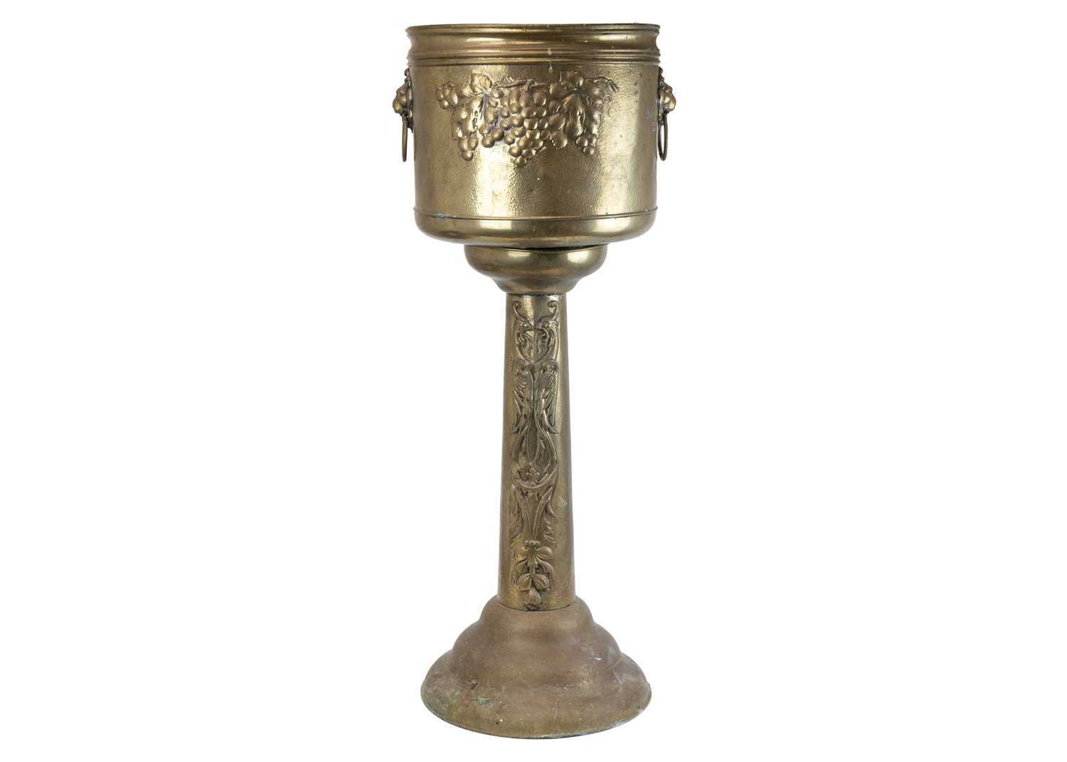 Lot 66 - A brass jardiniere on stand, circa 1900.