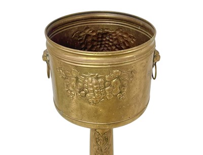 Lot 66 - A brass jardiniere on stand, circa 1900.