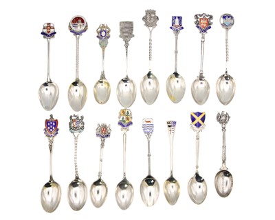 Lot 50 - A selection of 19 silver and enamel souvenir teaspoons.