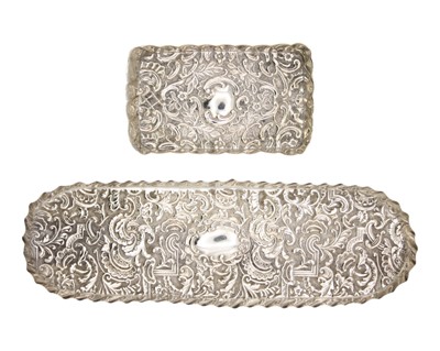 Lot 104 - Two Victorian silver embossed dressing table pin trays.