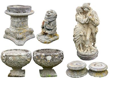 Lot 390 - A pair of reconstituted stone garden urns with floral decoration, raised on square bases.