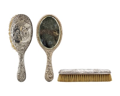 Lot 75 - A Victorian silver embossed three-piece dressing table set by Henry Matthews.