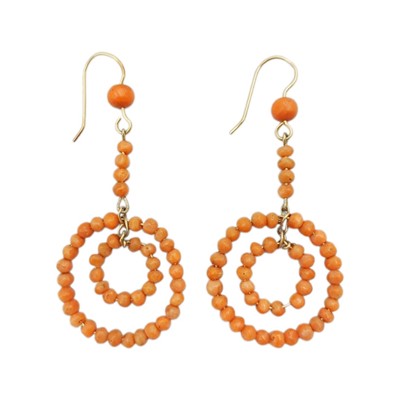 Lot 103 - A pair of red coral pendant earrings fitted on 9k gold hooks.