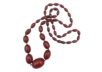 Lot 119 - A large graduated cherry amber style bead necklace.