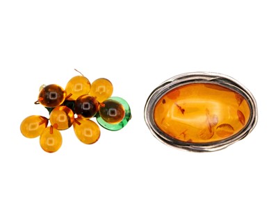 Lot 40 - A silver and amber brooch, together with an amber style brooch.