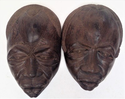 Lot 49 - A pair of large figured hardwood tribal masks,...