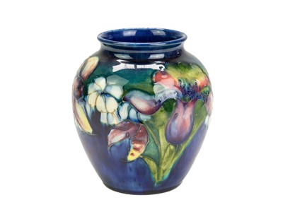 Lot 381 - A Moorcroft orchid pattern baluster vase.