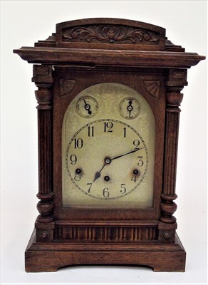 Lot 3303 - An early 20th century oak cased German mantel...
