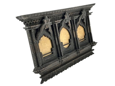 Lot 84 - An ornate Eastern hardwood triple frame.