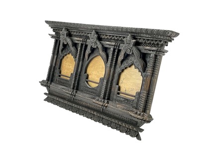 Lot 84 - An ornate Eastern hardwood triple frame.