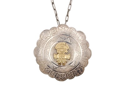Lot 45 - An Aztec silver and 18k gold brooch/pendant on a silver chain.