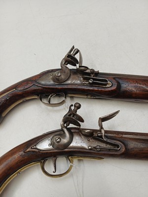 Lot 273 - Two reproduction brass mounted flintlock pistols.
