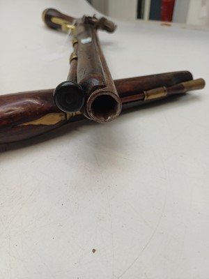 Lot 273 - Two reproduction brass mounted flintlock pistols.