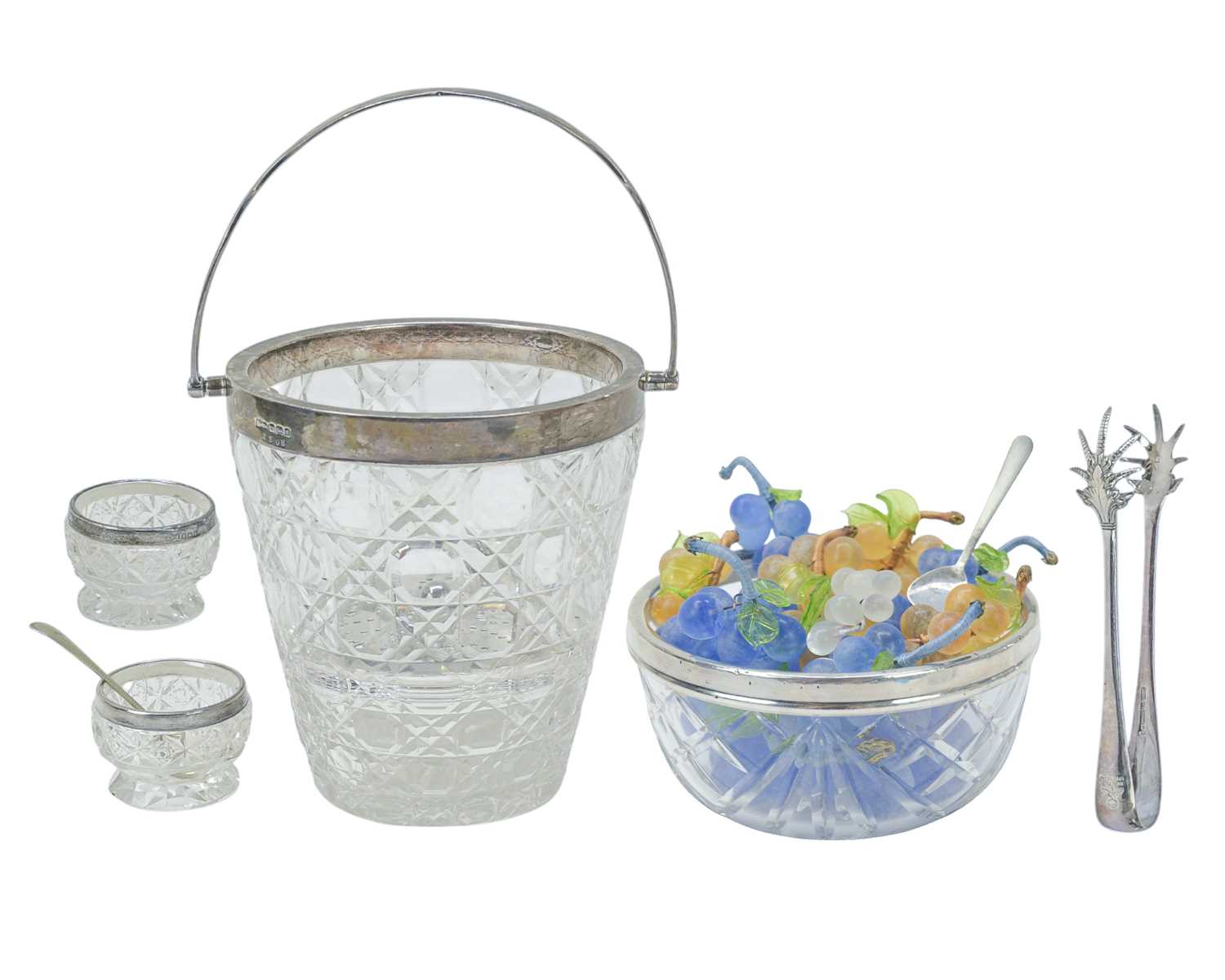 Lot 247 - An Edwardian cut glass ice bucket with silver rim, handle and strainer.