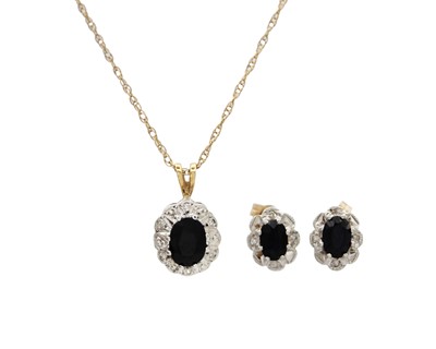 Lot 68 - A 9k gold sapphire and diamond set pendant necklace with matching pair of earrings.
