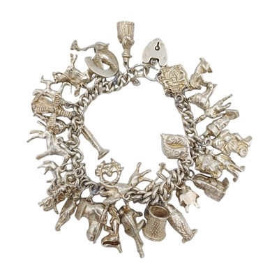 Lot 127 - A silver charm bracelet.