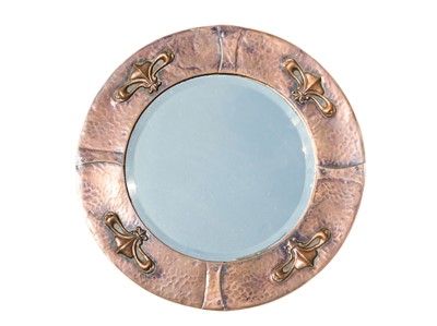 Lot 820 - An Arts and Crafts circular copper framed mirror.