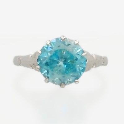 Lot 128 - A 9k white gold and blue zircon set solitaire ring.