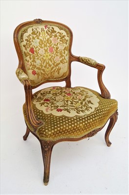 Lot 3439 - A French walnut upholstered open armchair,...