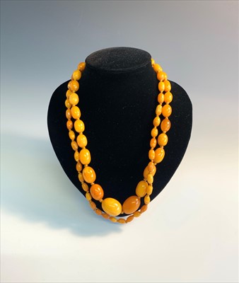 Lot 2602 - A 'butterscotch' amber long necklace, the...