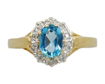 Lot 96 - A 9k gold topaz and diamond cluster ring.