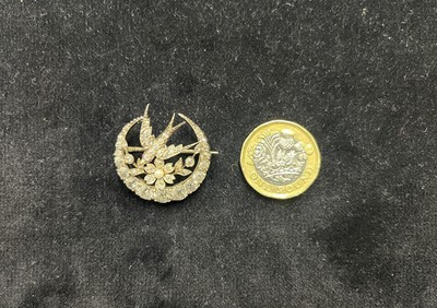 Lot 7 - A Scottish Victorian diamond and seed pearl crescent and swallow bird brooch by Aitchison.