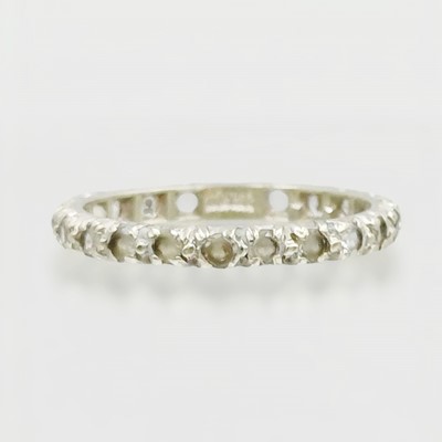 Lot 116 - A 9k white gold synthetic spinel eternity band ring.