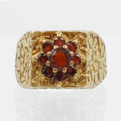 Lot 162 - A 9k gold garnet set dress ring.