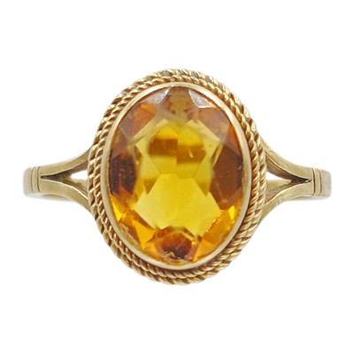 Lot 115 - A 9k gold citrine solitaire ring.