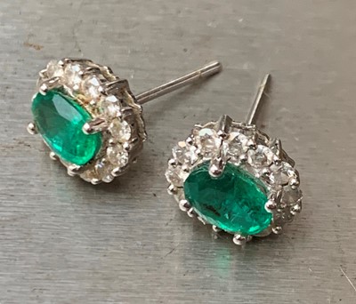 Lot 2624 - A pair of 18ct white gold oval emerald and...