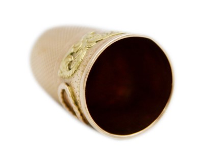 Lot 156 - A 19th century yellow and rose gold thimble.