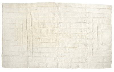 Lot 672 - A large Moroccan Berber cream wool rug.