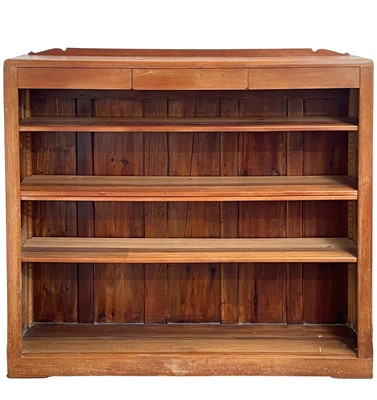 Lot 873 - An Arts and Crafts walnut open bookcase.