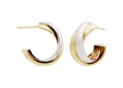 Lot 8 - A pair of 18k white and yellow gold hoop earrings.