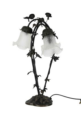 Lot 111 - A modern bronze effect three branch table lamp with glass shades.