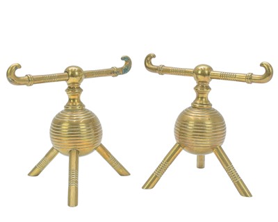 Lot 114 - A pair of brass fire dogs attributed to Christopher Dresser.