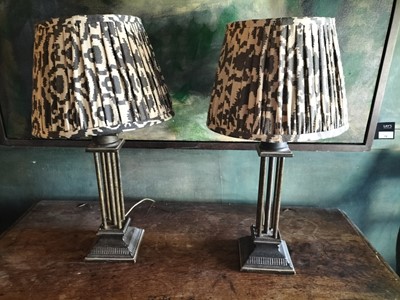 Lot 12 - A pair of painted metal column form table lamps and shades.