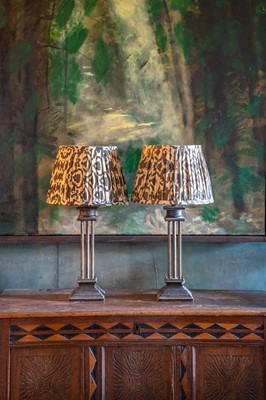 Lot 12 - A pair of painted metal column form table lamps and shades.