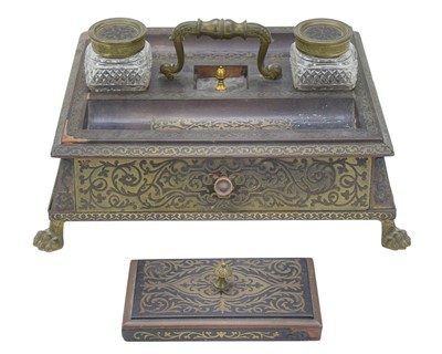 Lot 181 - A Regency ebonised and inlaid brass desk stand in the manner of Boulle.
